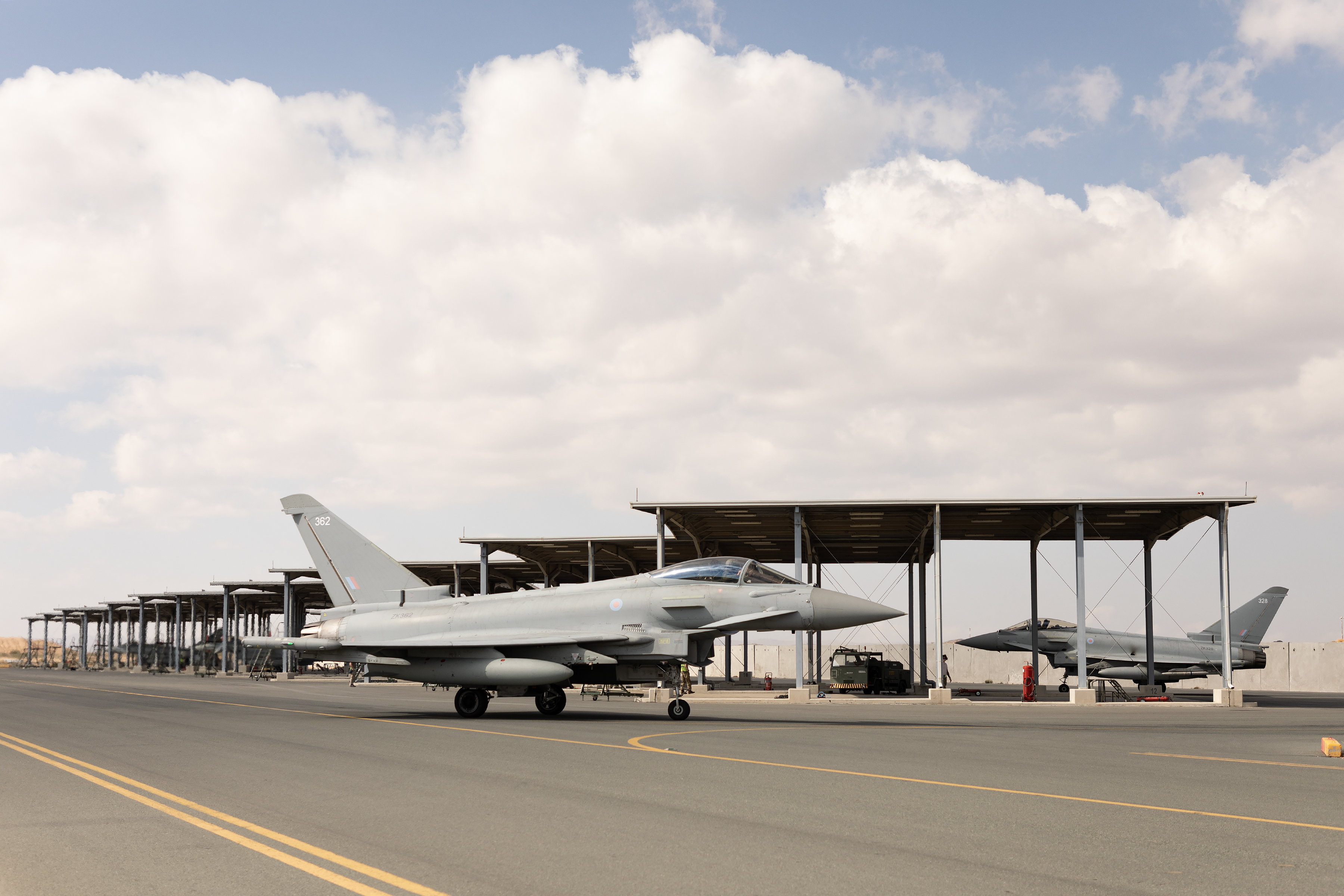 Image shows RAF Typhoons under temporary hangars on the airfield.